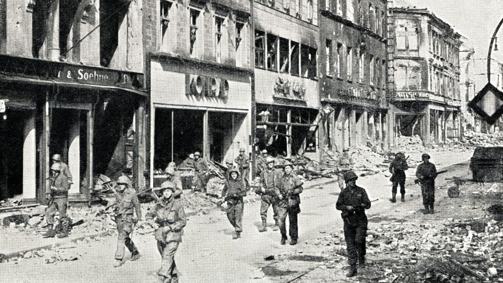 US-Truppen maschieren im März 1945 durch die heutige Eisenbahnstraße in Saarbrücken, auf der Suche nach letzten deutschen Scharfschützen