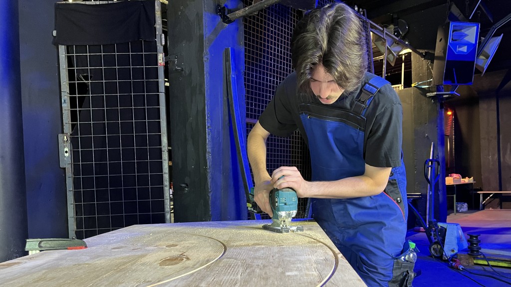 Schüler sägt Holz für Litfasssäule aus.