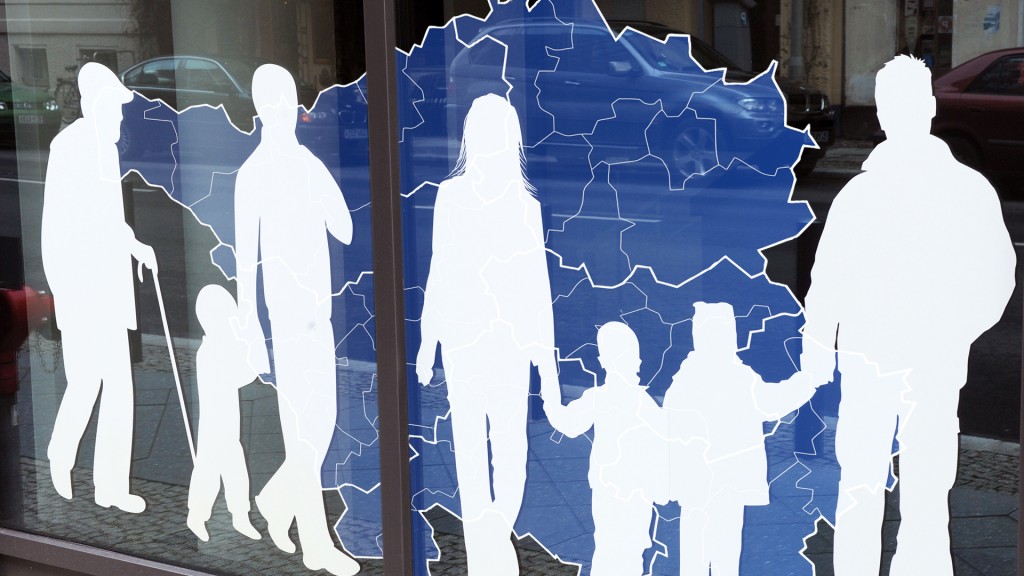 Figuren von Menschen in verschiedenem Alter sind auf einer Fensterfront