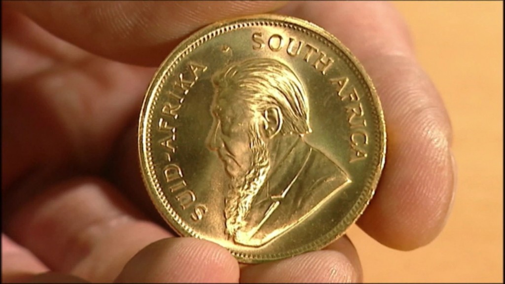Foto: Hand mit Goldmünze