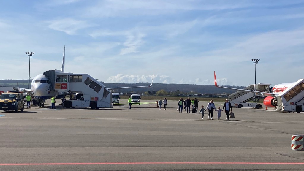 Passagiere auf dem Rollfeld des Saarbrücker Flughafens 