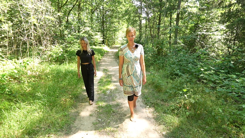 Foto: Celina Fries und eine Achtsamkeits-Coachin spazieren achtsam durch den Wald.