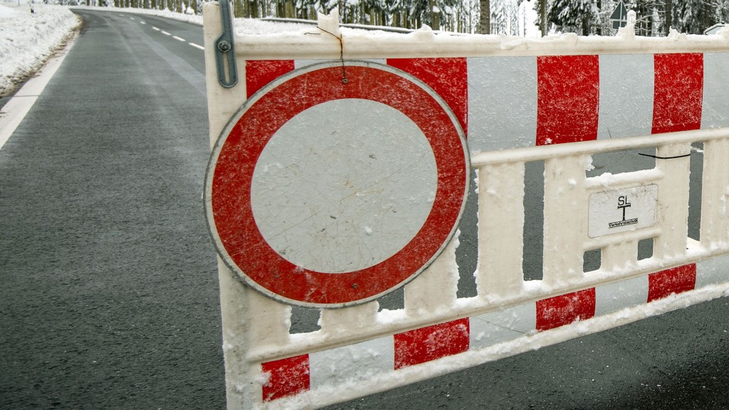 Eine Absperrung steht auf vereisten Straße