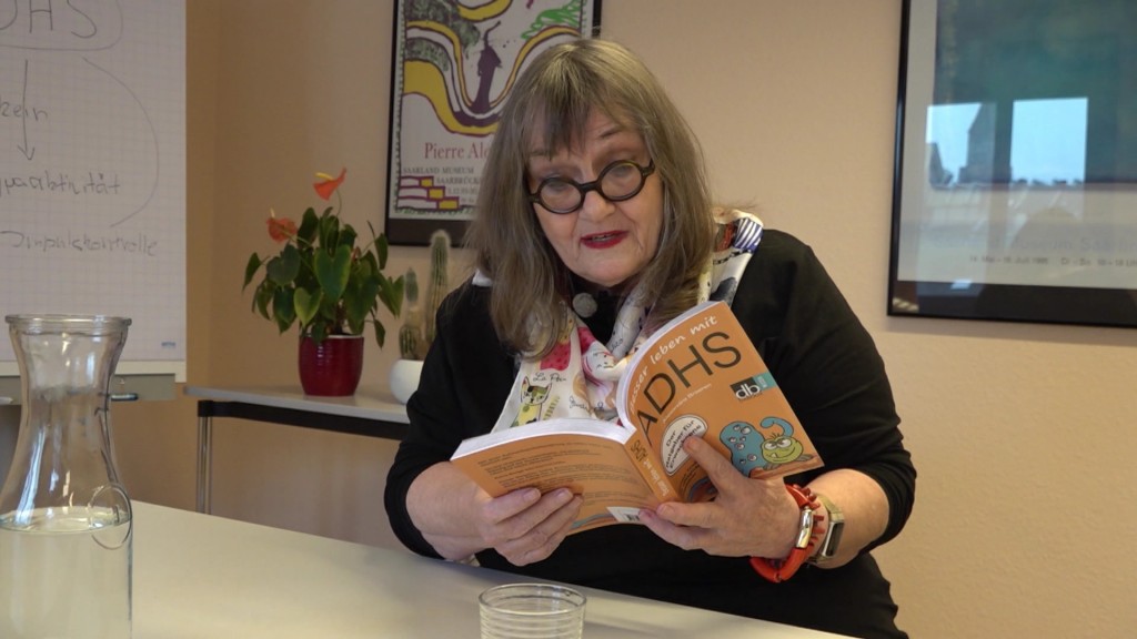 Foto: Frau mit einem Buch mit ADHS im Titel