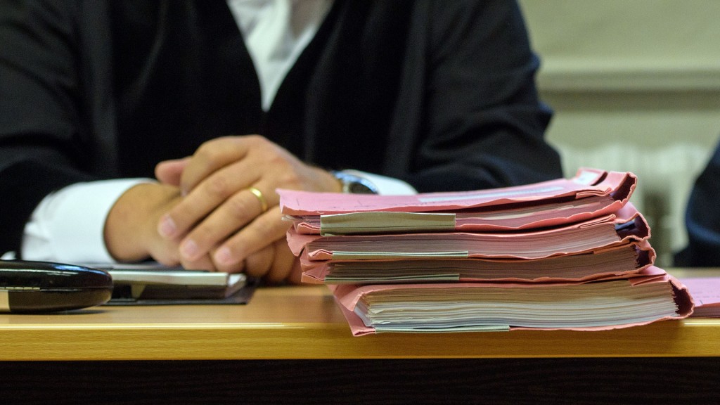 Foto: Symbolbild: ein Richter sitzt hinter einem Stapel Aktenmappen