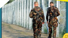 Soldaten an einem Grenzzaun